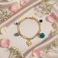 Zapestnica Blue Trend Charms - flat lay z rožami - kirurško jeklo 316L zlata pozlata